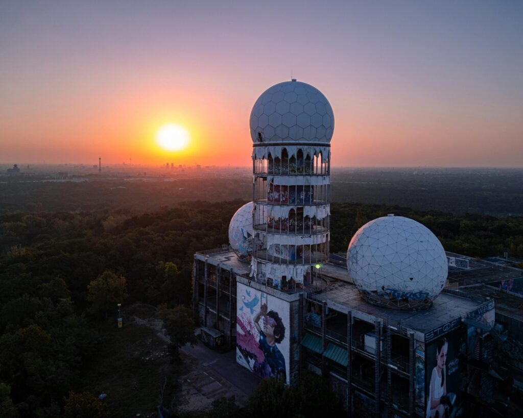 Aerial view of the Teufelsberg listening station in Berlin at sunset, capturing its historic architecture.